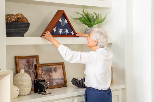 Folded burial flag in a solid wood memorial display case
