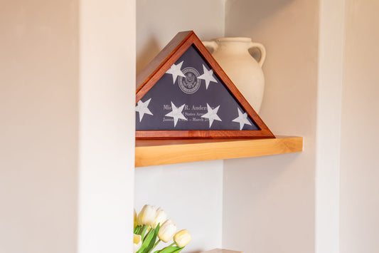 Folded flag displayed in a wood case at home